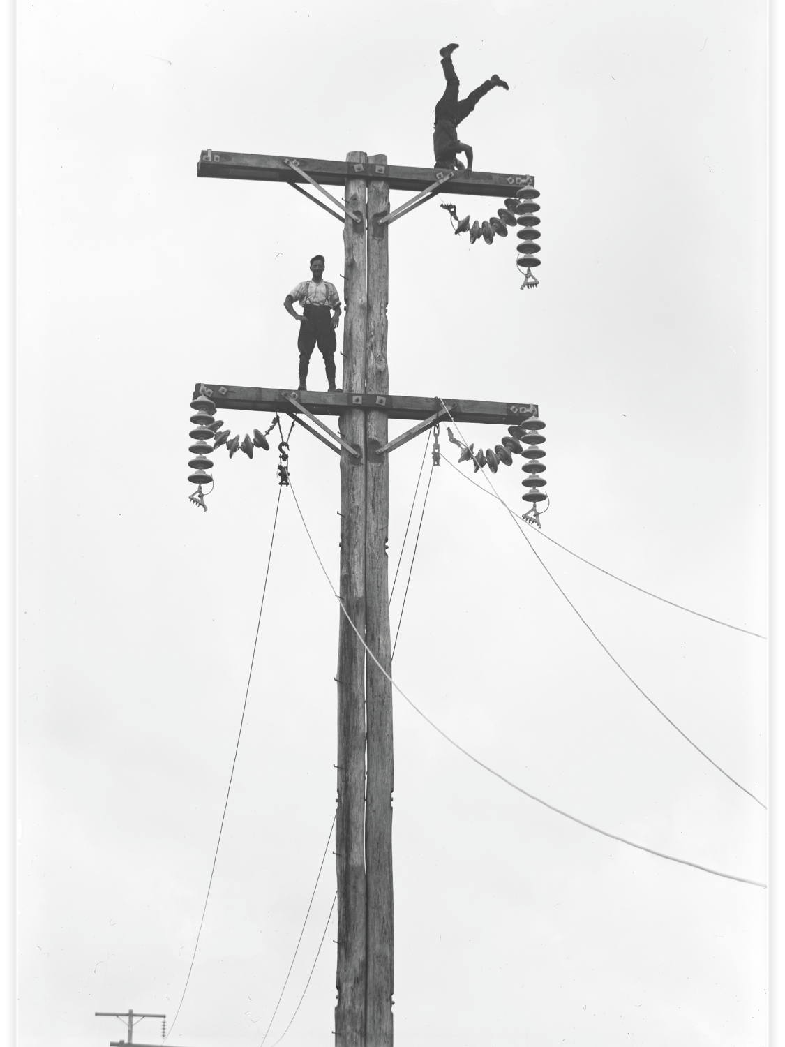 C. Cusack and mate on a Queen St, Levin transmission pole